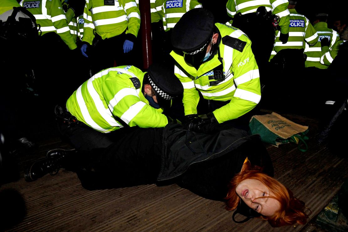 A woman is arrested at a vigil on Saturday in memory of murdered Londoner Sarah Everard.