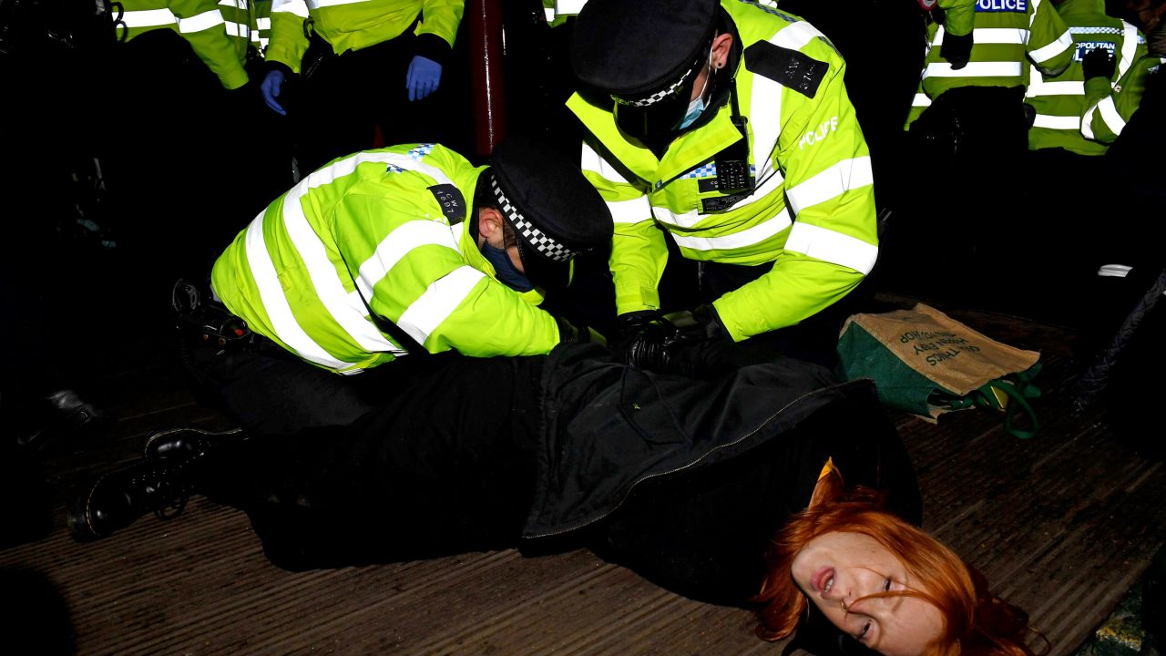 A woman is arrested at a vigil on Saturday in memory of murdered Londoner Sarah Everard.