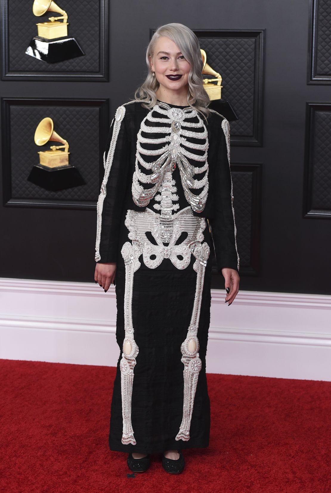Phoebe Bridgers arrives to the Grammys in a signature skeleton suit, this one by designer Thom Browne. 