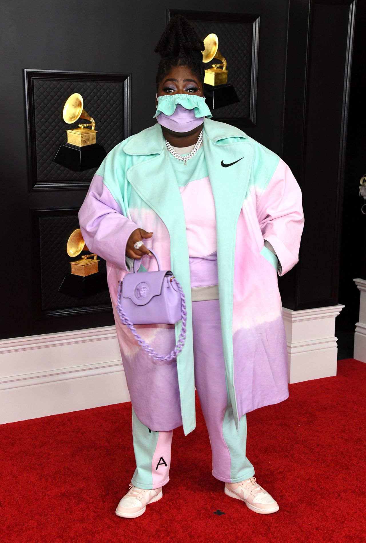 Chika arrives on the red carpet in a pastel Nike suit and matching face mask.