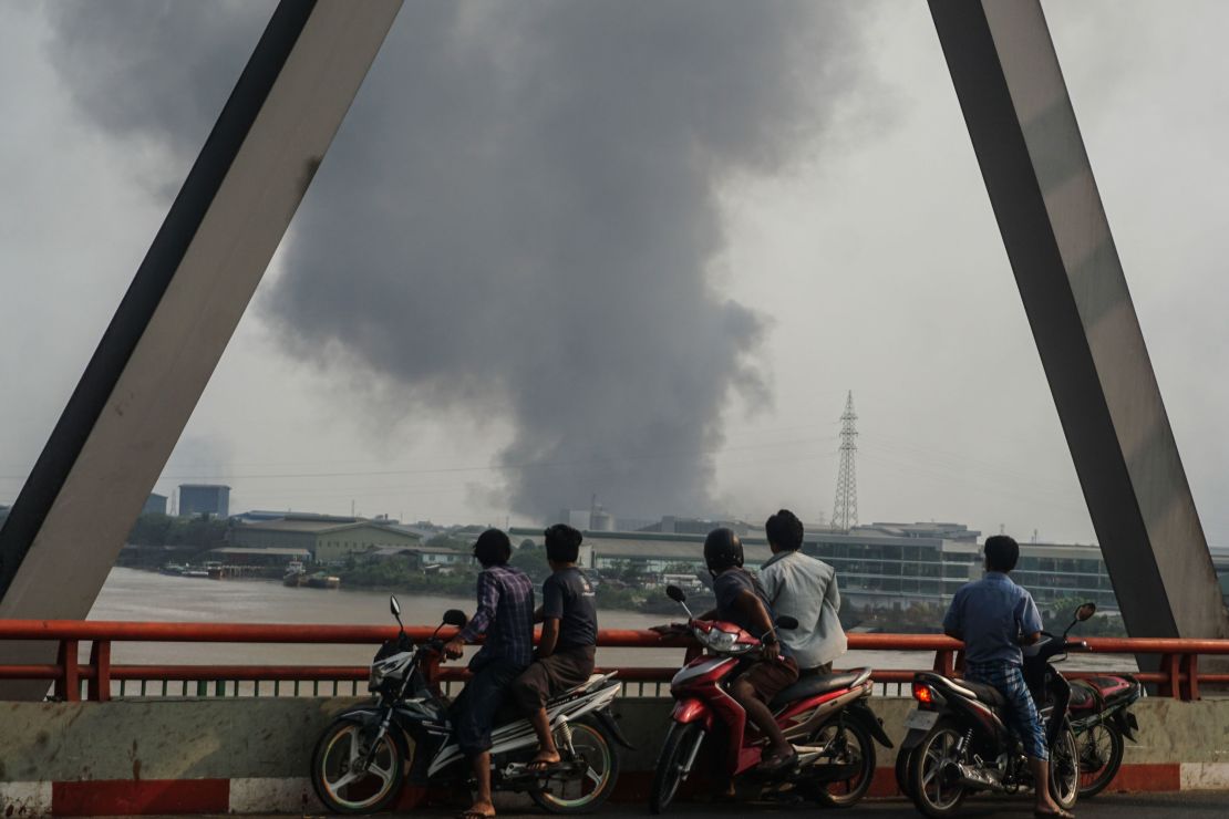 Smoke rises as protests against military coup and detention of elected government members continue in Hlaingtharya Township, Yangon, on March 14.
