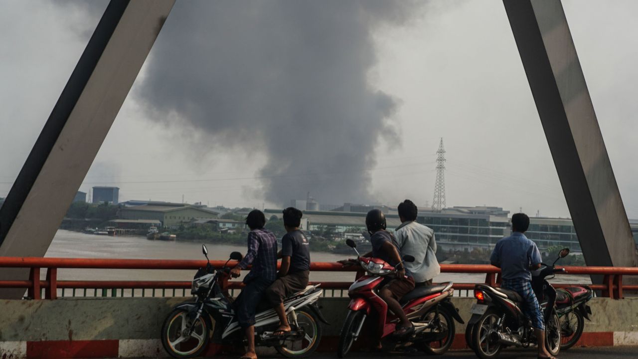 Smoke rises as protests against military coup and detention of elected government members continue in Hlaingtharya Township, Yangon, on March 14.