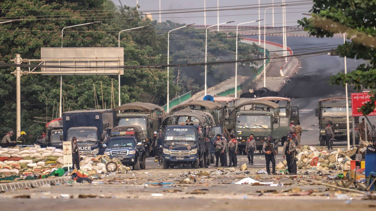 Security forces block the road as people continue to protest against military coup and detention of elected government members in in Hlaingtharya Township, Yangon on March 14.