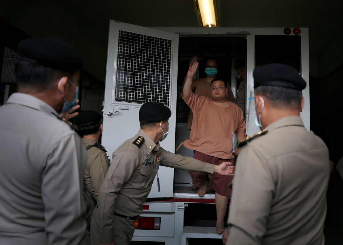 A leader of Thai pro-democracy activists Parit 'Penguin' Chiwarak flashes the three-finger salute as he arrives to face charges at the Criminal Court in Bangkok, Thailand, on March 15. 
