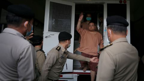 A leader of Thai pro-democracy activists Parit 'Penguin' Chiwarak flashes the three-finger salute as he arrives to face charges at the Criminal Court in Bangkok, Thailand, on March 15.