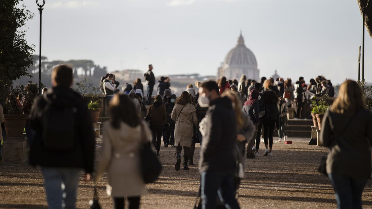 People walk in central Rome, Italy, on March 14, 2021, a day before stricter coronavirus measures came into force.