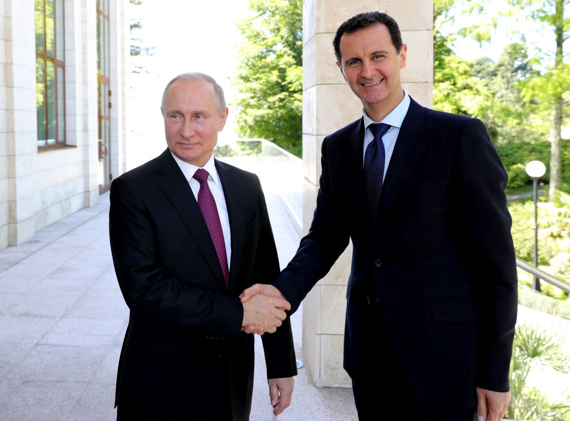 Russian President Vladimir Putin shakes hands with his Syrian counterpart Bashar al-Assad during a meeting in Sochi on May 17, 2018. 