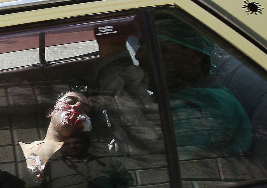 An injured man lying in the back of a vehicle is rushed to a hospital in Daraa, Syria, on March 23, 2011. Violence flared in Daraa after a group of teens and children were arrested for writing political graffiti. Dozens of people were killed when security forces cracked down on demonstrations.