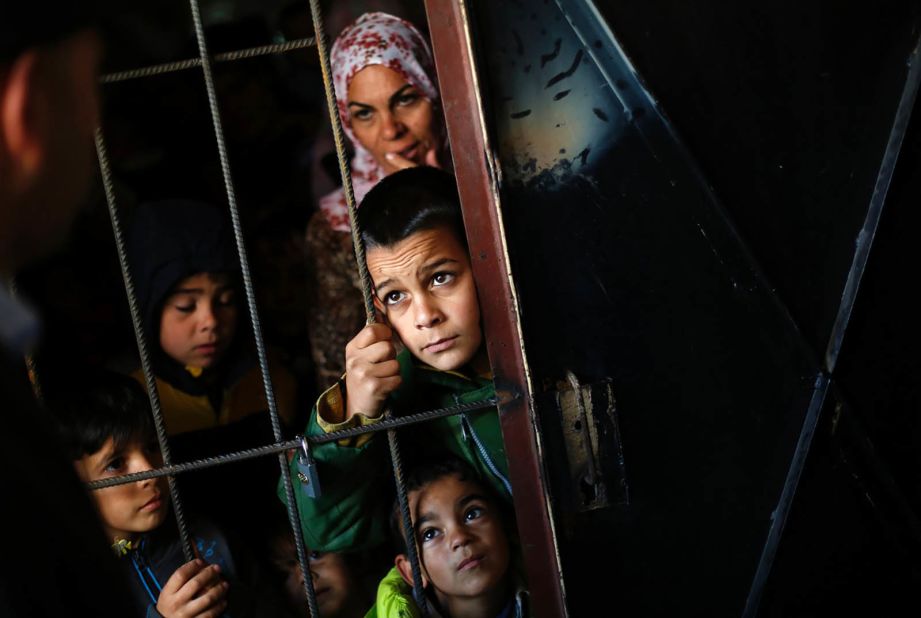 Syrian children wait as doctors perform medical checkups at a refugee center in Sofia, Bulgaria, on October 26, 2013.