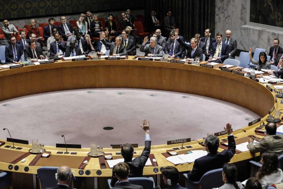 Members of the UN Security Council raise their hands on April 12, 2017, as they vote in favor of a draft resolution that condemned the reported use of chemical weapons in Syria.