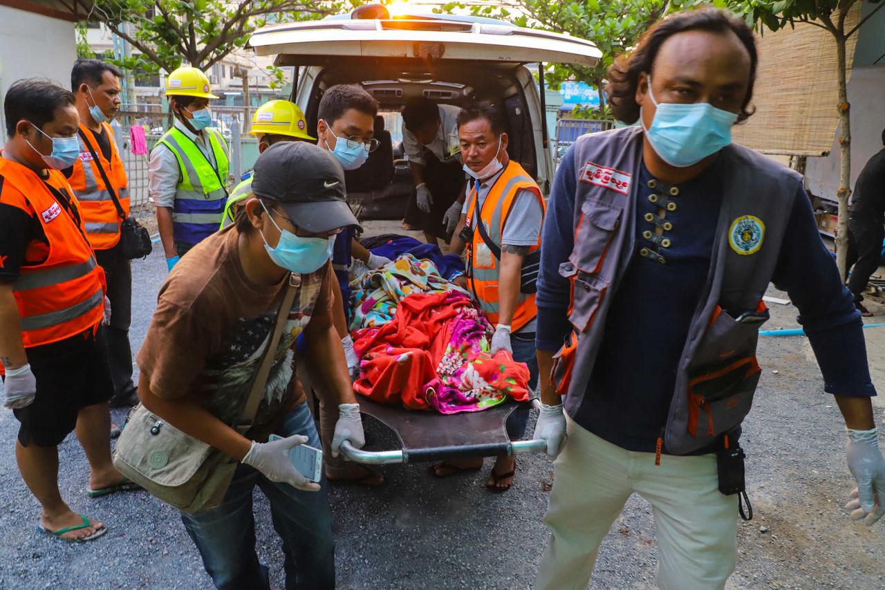Emergency workers transport the body of Shel Ye Win, who was shot by security forces in Mandalay.