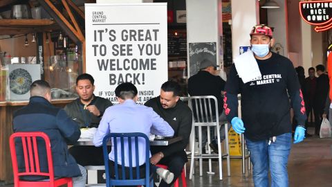 People enjoy lunch at Grand Central Market as indoor dining reopens in Los Angeles on March 15, 2021. 