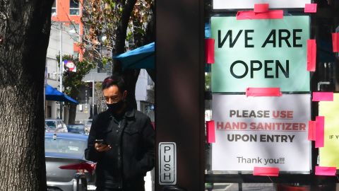 A "We Are Open" sign is seen on the side of a restaurant as indoor dining reopens in Los Angeles, on March 15, 2021.