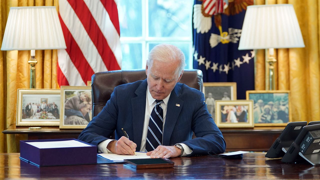 US President Joe Biden signs the American Rescue Plan on March 11, 2021, in the Oval Office of the White House in Washington, DC. - Biden signed the $1.9 trillion economic stimulus bill and will give a national address urging "hope" on the first anniversary of the start of the coronavirus pandemic. (Photo by MANDEL NGAN / AFP) (Photo by MANDEL NGAN/AFP via Getty Images)
