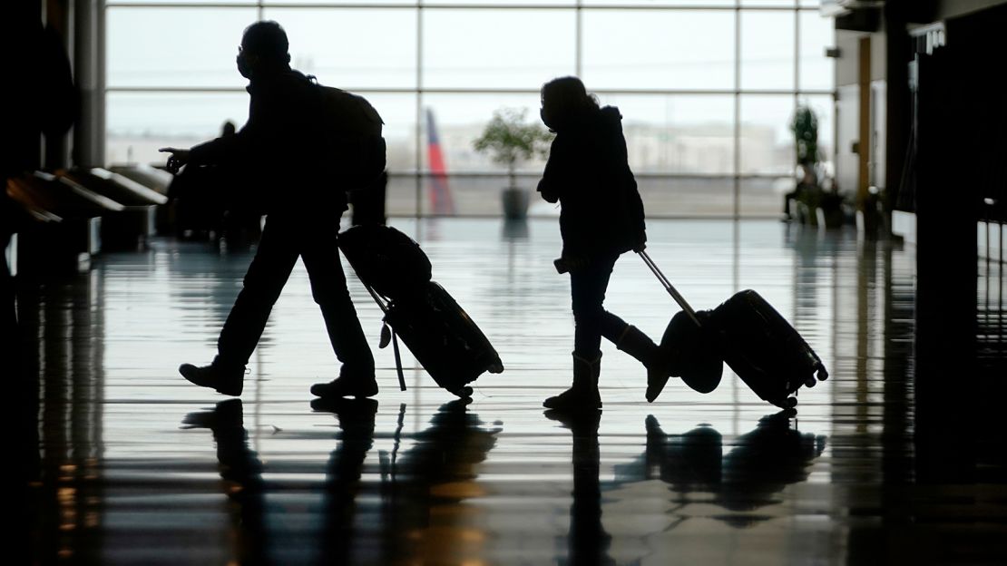 Travelers last week walk through the Salt Lake City International Airport.
