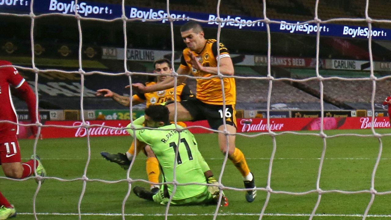 Conor Coady (right) and Rui Patricio collide during Monday's game.