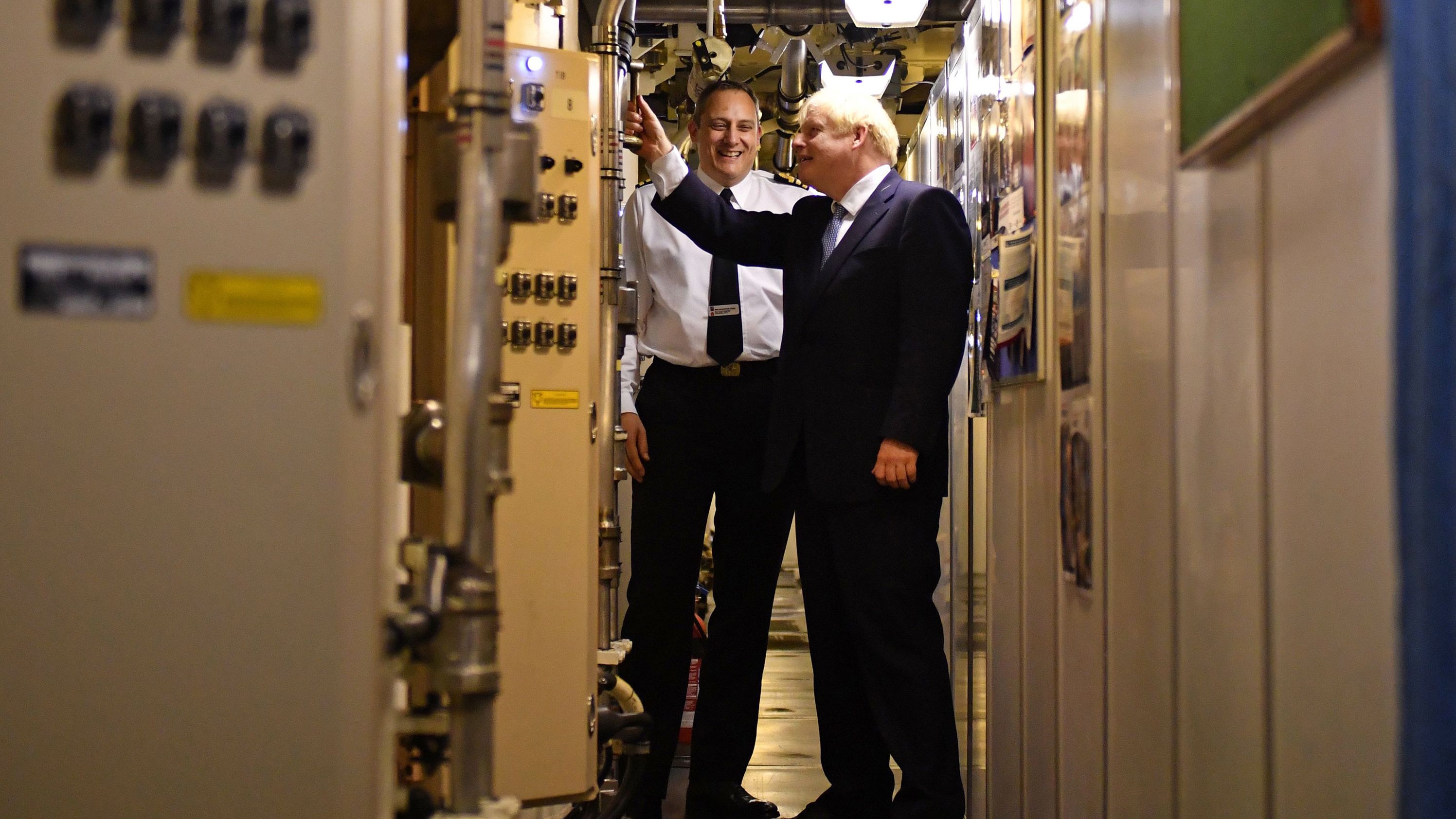 Commander Justin Codd, left, chats with British Prime Minister Boris Johnson  aboard Vanguard-class submarine HMS Victorious during a visit to the Faslane naval base  north of Glasgow, Scotland on July 29, 2019.