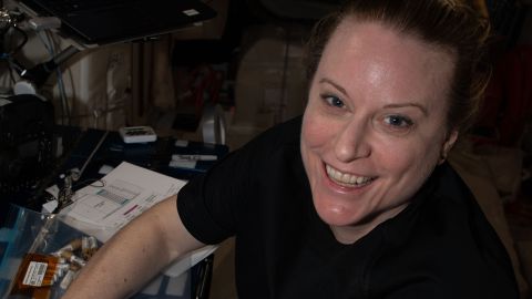 NASA astronaut Kate Rubins collects tubes containing swab samples of microbes on the space station.