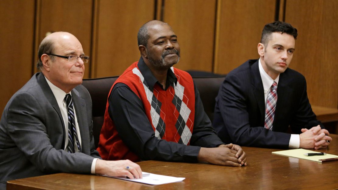 Kwame Ajamu, center, formally known as Ronnie Bridgeman, sits in the courtroom between attorney's Terry Gilbert and David Mills, right, in 2014. 