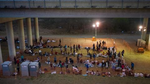 Asylum seeking migrant families and unaccompanied minors from Central America take refuge in a makeshift U.S. Customs and Border Protection processing center under the Anzalduas International Bridge after crossing the Rio Grande river into the United States from Mexico in Granjeno, Texas, U.S., March 12, 2021.