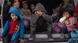 Asylum seeking migrant children from Central America take refuge from the rain in the back of a U.S. Border Patrol vehicle as they await to be transported after crossing the Rio Grande river into the United States from Mexico on a raft in Penitas, Texas, U.S., March 14, 2021. Pictured in the front row are Yoandri, 4, Michael, 5 and Yojanlee, 2, all from Honduras. REUTERS/Adrees Latif