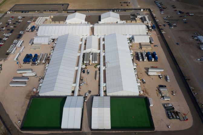 This aerial photo, taken on March 15, shows a temporary processing center set up by US Customs and Border Protection in Donna, Texas. Lawyers who recently spoke with <a href="index.php?page=&url=https%3A%2F%2Fwww.cnn.com%2F2021%2F03%2F13%2Fus%2Fborder-detention-conditions%2Findex.html" target="_blank">children at the facility</a> say they're terrified, crying and worried about not being able to call their parents.