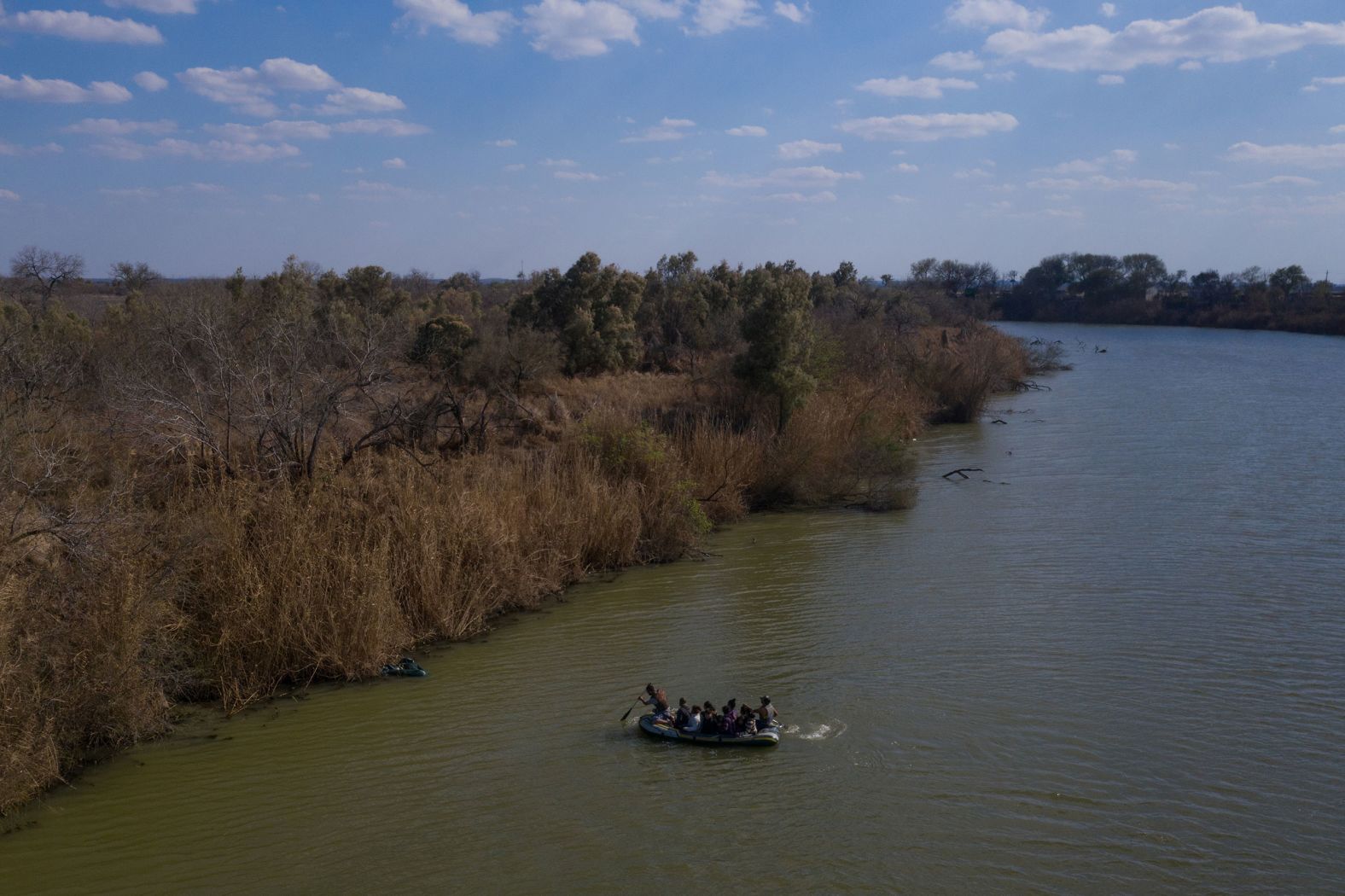 Smugglers use a raft to transport migrant families and children across the Rio Grande into Texas on March 6.