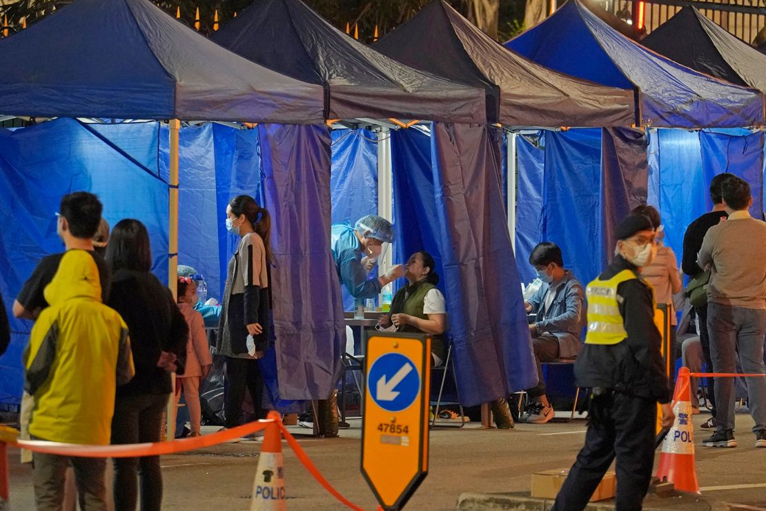 Government workers set up a temporary testing center for Covid-19 cordon outside an apartment block at Robinson Road in Hong Kong on Sunday.