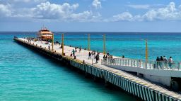 Tourists walk at a pier to get on a boat to Cozumel Island, in Playa del Carmen, Quintana Roo state, Mexico, on March 3, 2021, amid the coronavirus pandemic (Photo by Daniel SLIM / AFP) (Photo by DANIEL SLIM/AFP via Getty Images)