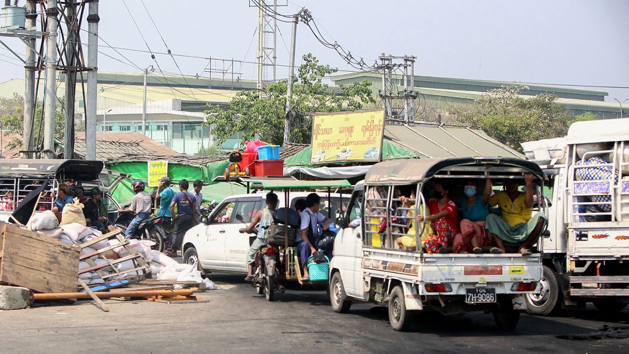 People in cars and trucks flee the Hlaingtharya township in Yangon on March 16, as security forces continue a crackdown on protests in the area.