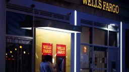 A pedestrian walks past automated teller machines (ATM) at a Wells Fargo bank branch at night in Washington, D.C., U.S., on Thursday, Jan. 7, 2021. Wells Fargo & Co. is scheduled to release earnings figures on January 15. Photographer: Ting Shen/Bloomberg via Getty Images
