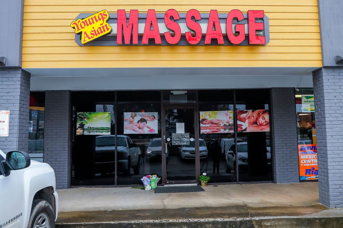 Flowers left by well-wishers sit at the entrance to Young's Asian Massage spa in Acworth, Georgia, on March 17.