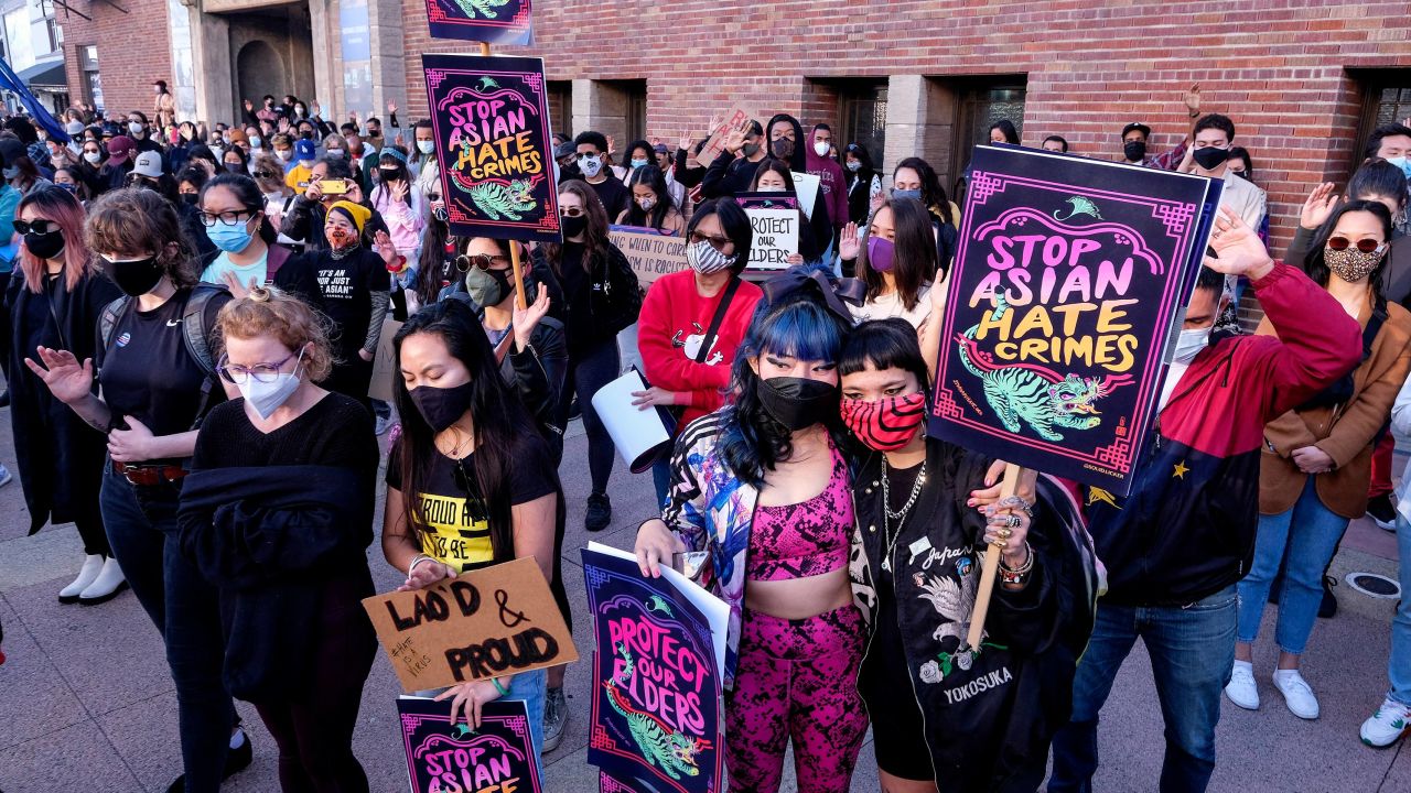 Demonstrators wearing face masks and holding signs take part in a rally "Love Our Communities: Build Collective Power" to raise awareness of anti-Asian violence in Los Angeles on March 13.