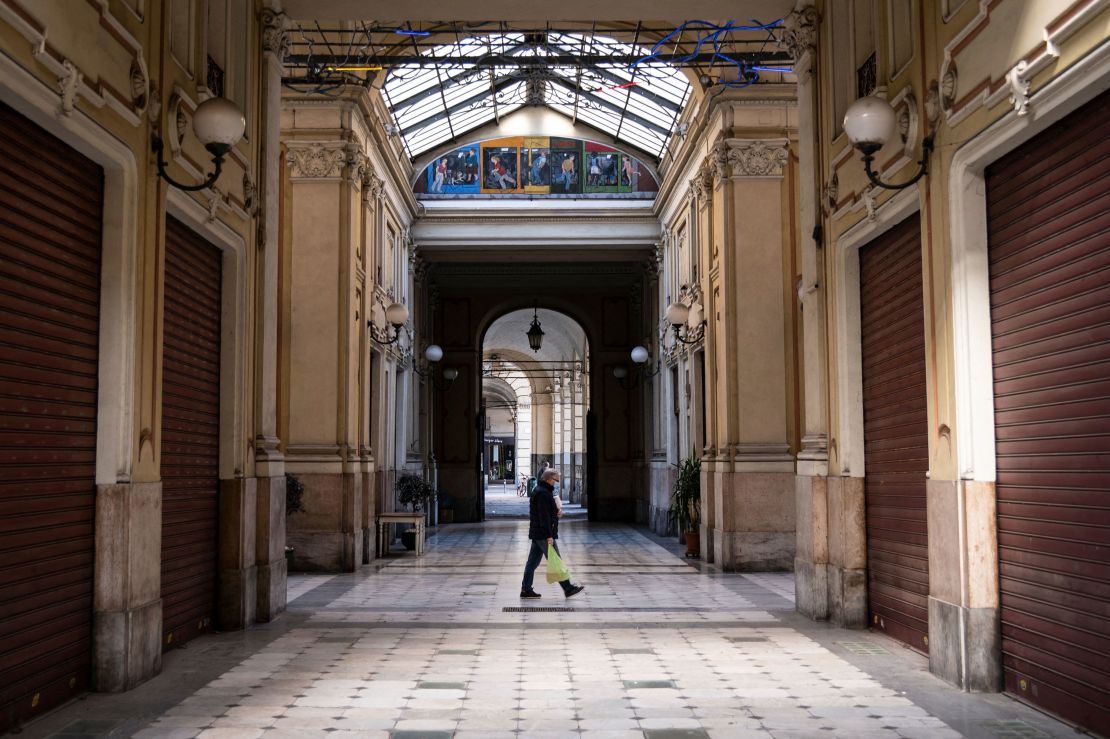 A man wearing a face mask walks across the Galleria Umberto I on March 17, 2021 in Turin during a new lockdown in response to the Covid-19 pandemic.