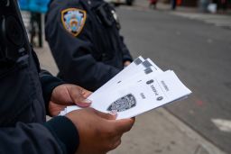 NYPD officers hand out information about hate crimes in Asian communities after mass shootings in Atlanta left 8 dead, including 6 Asian Americans, on March 17, 2021