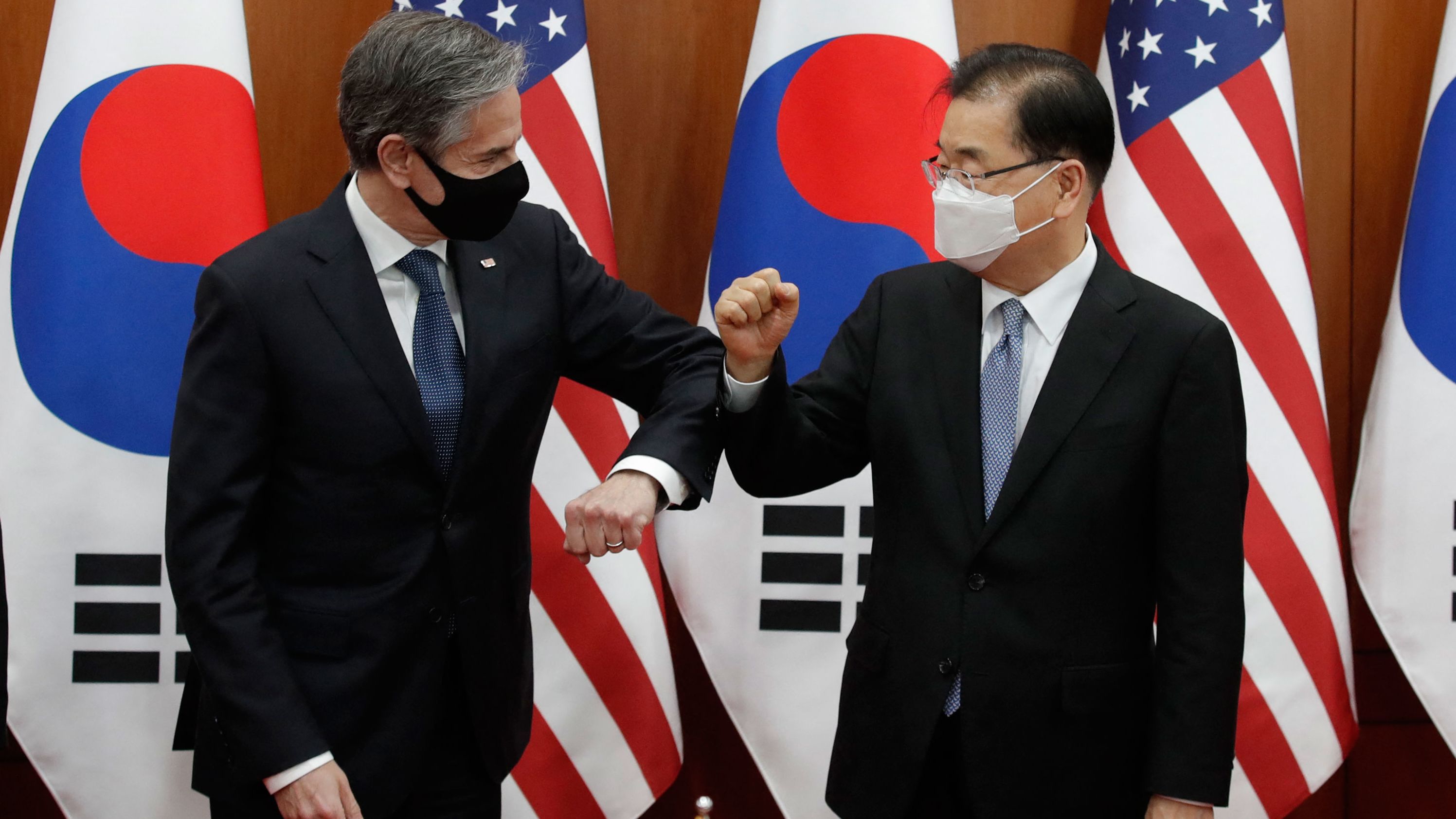 US Secretary of State Antony Blinken (L) bumps elbows with South Korean Foreign Minister Chung Eui-yong in Seoul on March 18, 2021. 