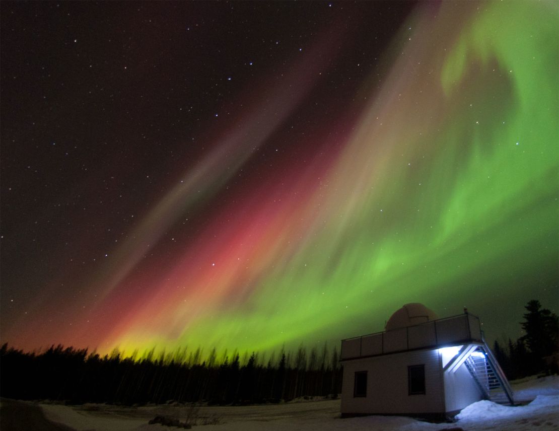 Red and green aurora are shown over Hankasalmi Observatory in Finland in 2015. Observatory volunteers will continuously record potential sounds associated with auroras this summer.