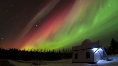 Red and green aurora are shown over Hankasalmi Observatory in Finland in 2015. Observatory volunteers will continuously record potential sounds associated with auroras this summer.