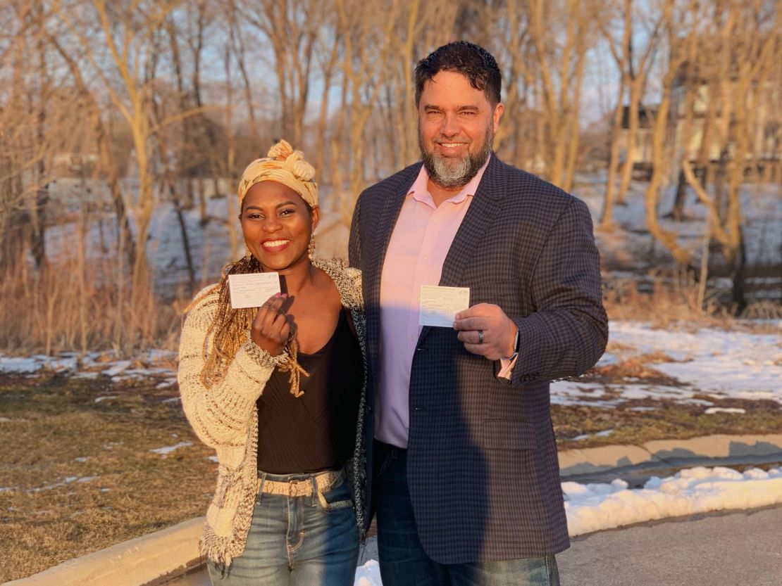 Gilda Vianeke-Wierson, left, and Arick Wierson show off their CDC Covid-19 vaccination cards.