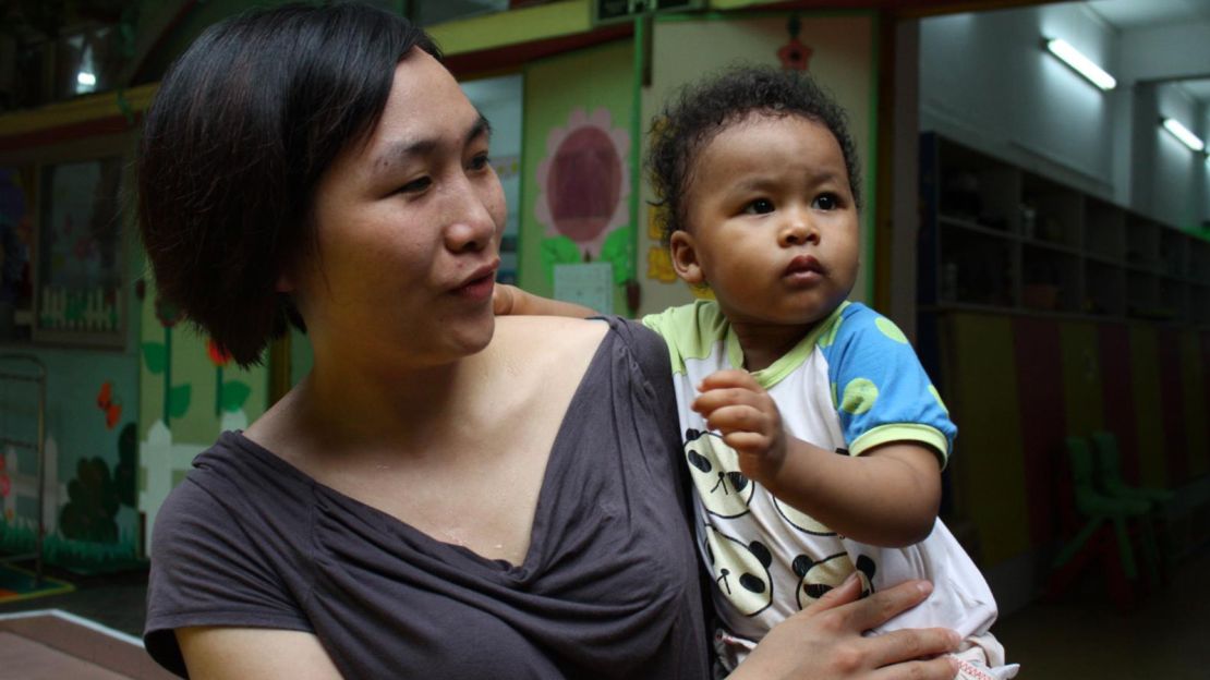 A Chinese woman in Guangzhou with her baby in 2016.