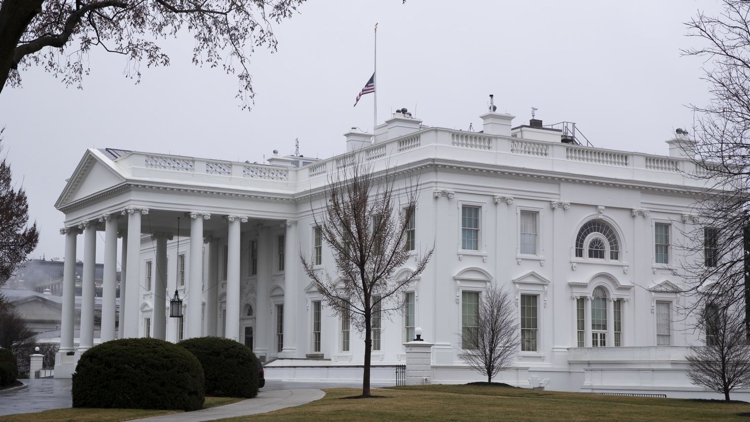 An American flag flies at half-staff over the White House in Washington, D.C., U.S., on Thursday, March 18, 2021. U.S. President Joe Biden ordered national flags to be flown at half-staff to honor the victims of the shootings in the Atlanta area that killed eight people. 