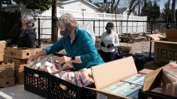 Volunteers prepare food packages for distribution at the Center for Food Action in Englewood, New Jersey, on March 9, 2021. The center helped 40,500 households last year, up from 23,000 the year before.
