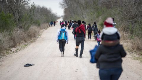Migrant families walk toward a Customs and Border Patrol processing center near Mission, Texas, on Tuesday, March 2, 2021. 