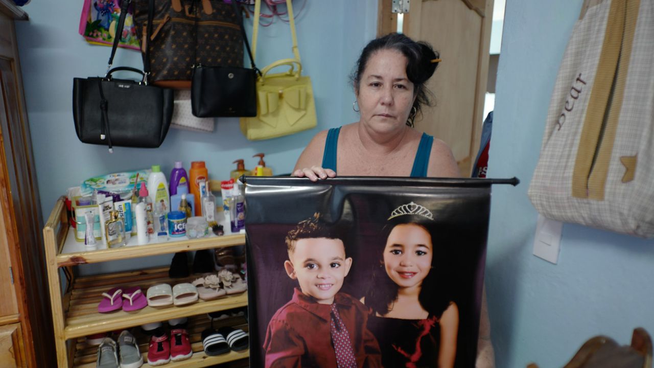Jimenez holds a picture of her grandchildren Kenna Mariana, 6, and Luis Nesto, 4.