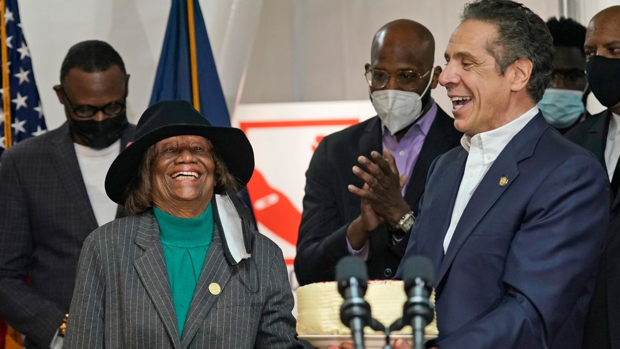 Cuomo presents Hazel Dukes, president of the New York State chapter of the NAACP, with a cake to celebrate her birthday.