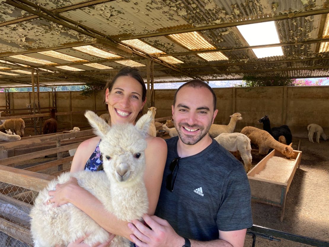 Aliza and Dan visiting alpacas in Chile in 2019.