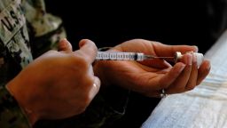A member of the U.S. Navy prepares a dose of the Pfizer-BioNTech Covid-19 vaccine at Naval Medical Center San Diego in San Diego, California, on Tuesday, December 15, 2020. 
