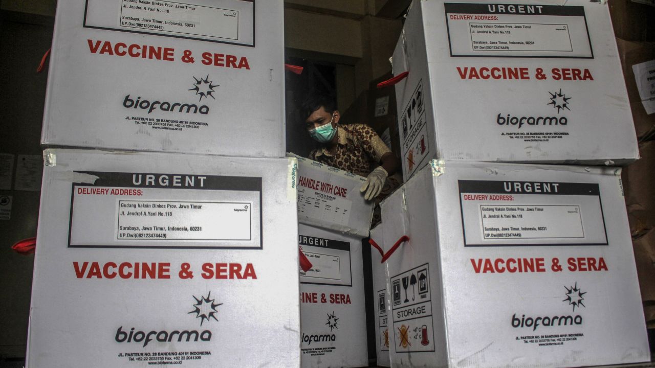 Health authorities officers unload Covid-19 vaccine produced by Sinovac China, under guard from Police at Pharmacy Warehouse in Surabaya, Indonesia on January 13, 2021.