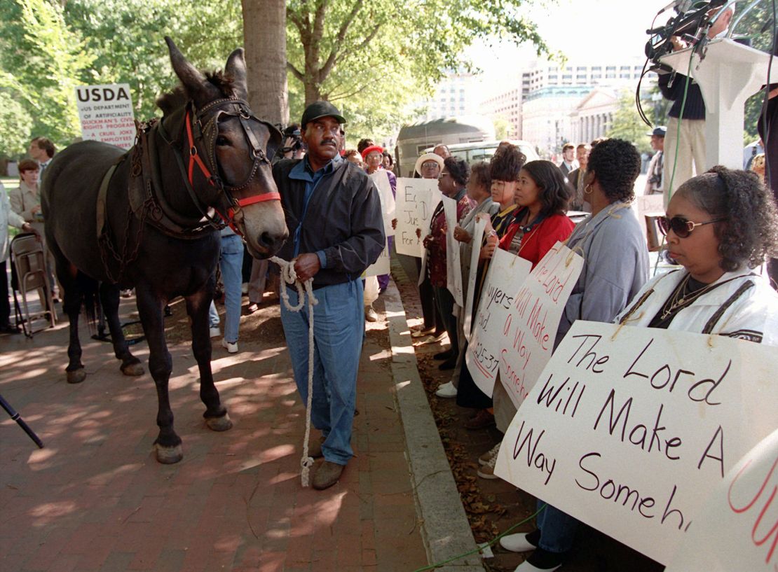 John Boyd Sr. and his mule Struggle walk among the crowd during a rally in Lafayette Park across from the White House Monday Sept. 22, 1997 to protest discrimination against Black Farmers by the Agriculture Department. 