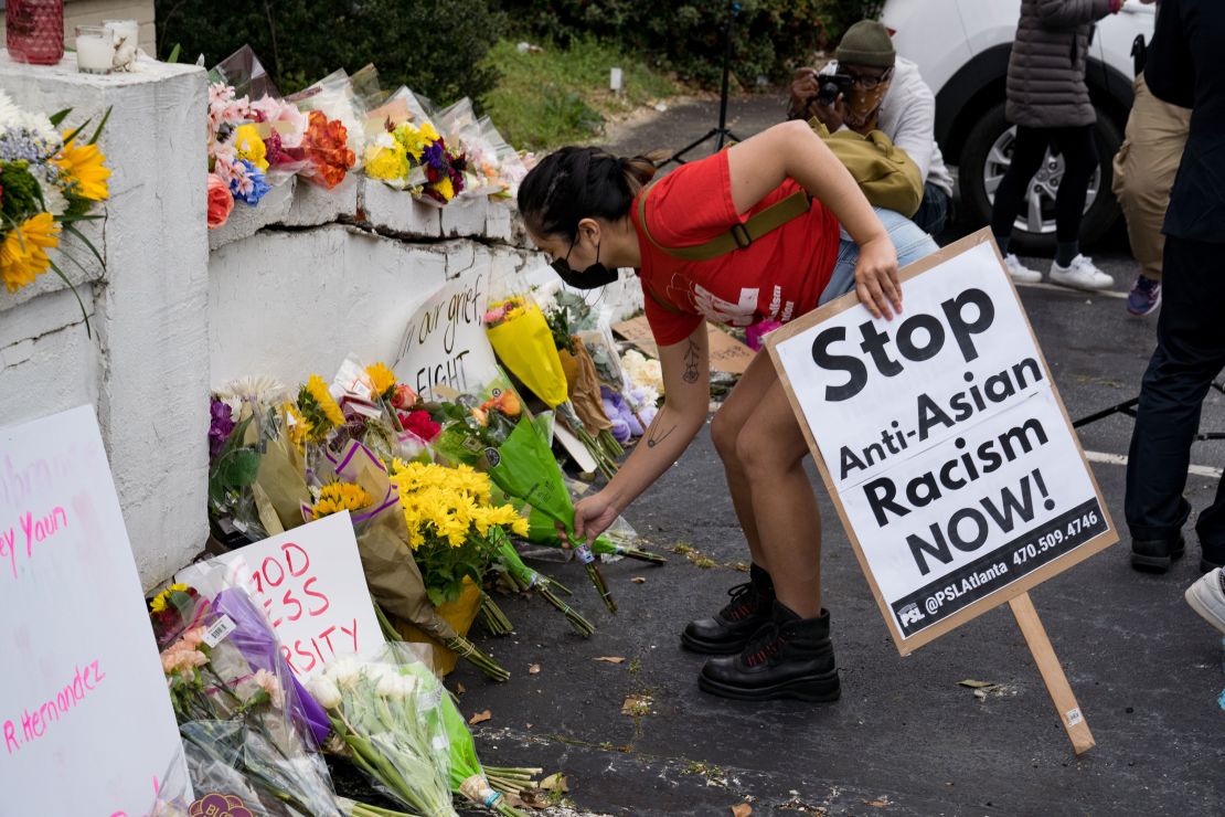 Activists place flowers during a protest in Atlanta against violence targeting women and Asians on Thursday, March 18.